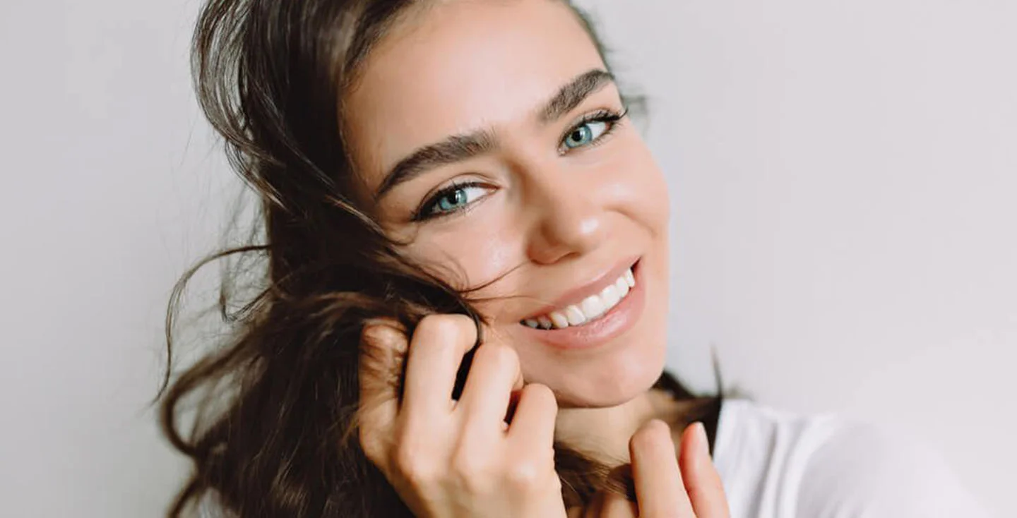 Woman holder her hair and smiling