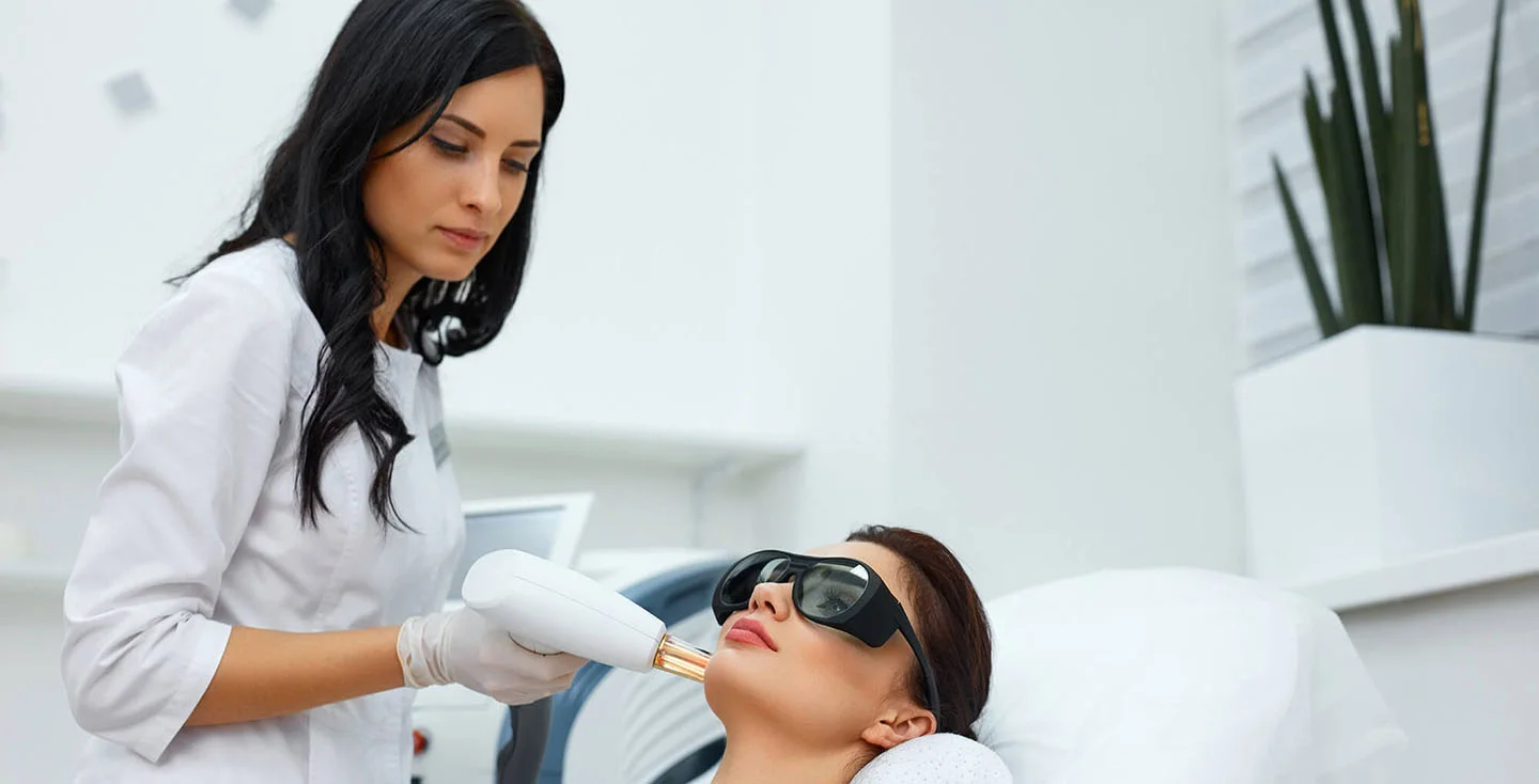 Dr. Yirae Ort using lasers for skin rejuvenation on a patient