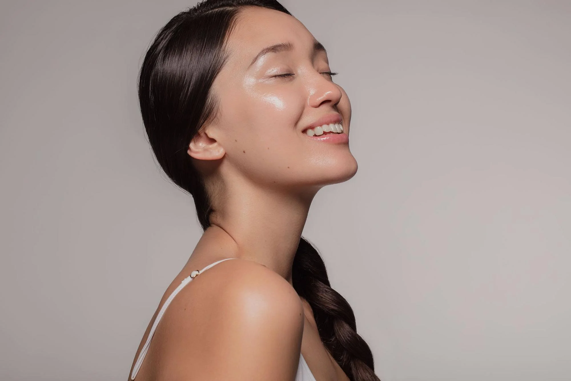 Asian woman posing with her eyes closed | Laser treatments in Bellevue and Seattle